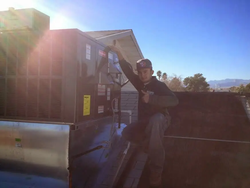 HVAC technician performing HVAC Inspection on a rooftop unit in Cuyahoga Falls